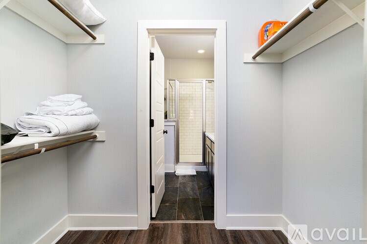 A bathroom with a towel stack on a shelf.