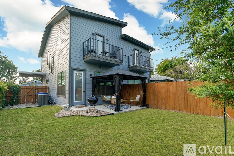 A house with a balcony and a backyard.