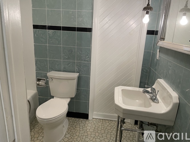 A white toilet and sink in a bathroom.