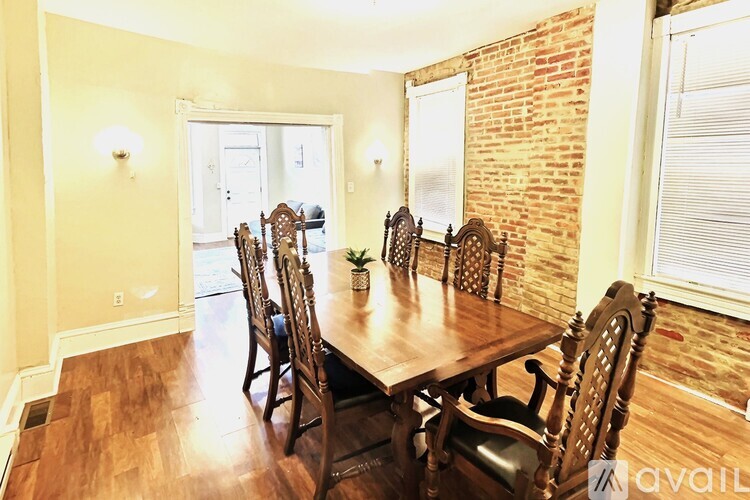 A dining room with a wooden table and chairs.