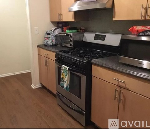 A kitchen with a black stove top oven and a black microwave.
