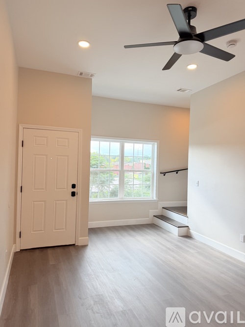 A kitchen with wooden floors and white appliances.