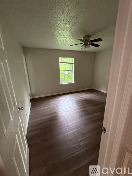 A white closet with a shelf and a door.
