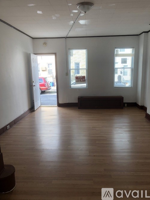 A room with wooden floors and white walls.