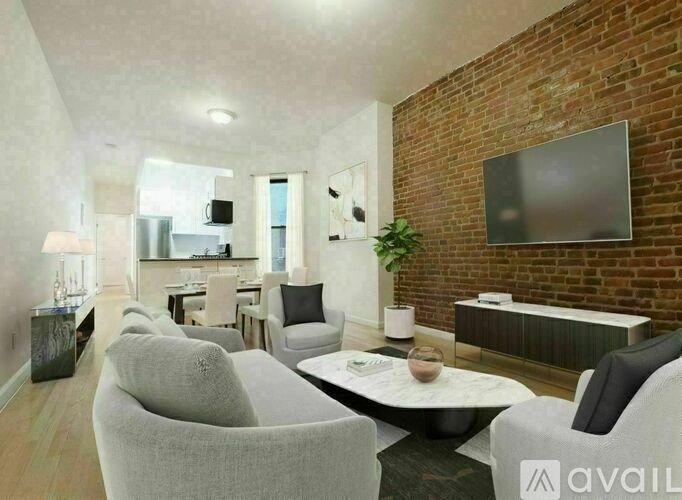 A living room with a brick wall and a television.