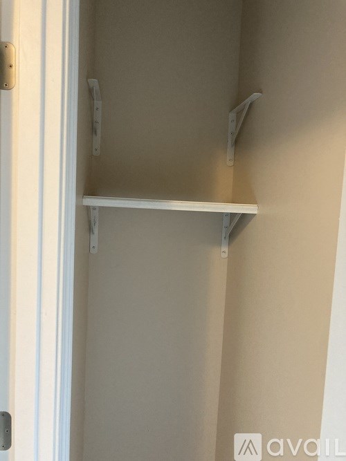Empty white shelves in a room.