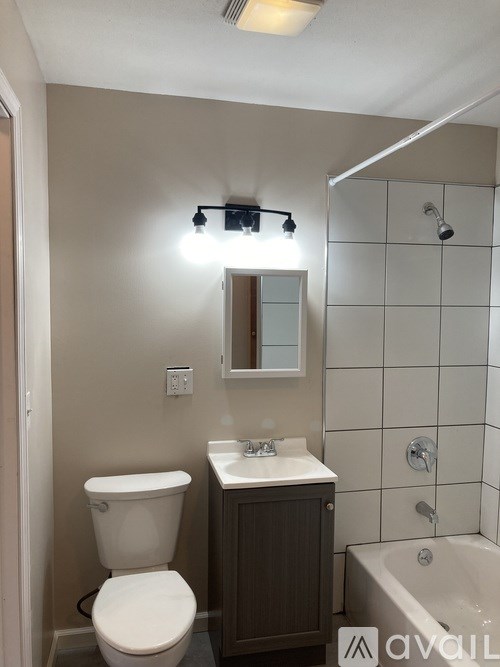 A bathroom with a toilet, sink, and bathtub.
