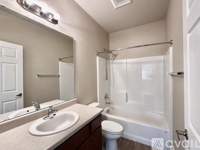 A white bathroom with a sink, toilet, and bathtub.