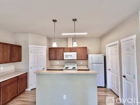 A kitchen with white cabinets and a white island.