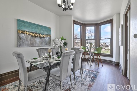 A dining room with a glass table and chairs.