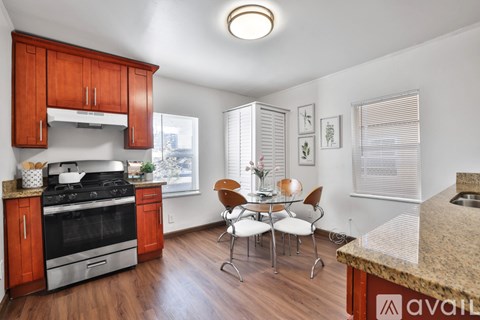 A kitchen with wooden cabinets and a granite countertop.