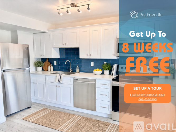 A kitchen with a refrigerator, sink, and cabinets is on display with an advertisement for a free first month of rent.