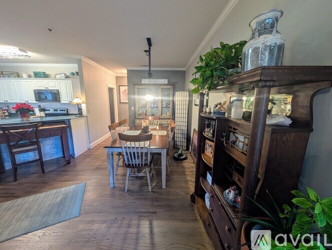 A dining room with a wooden table and chairs.