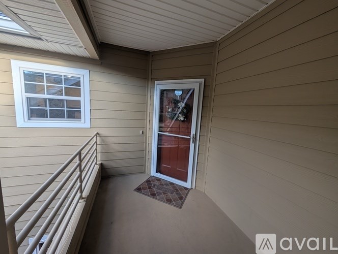 A balcony with a door leading to a deck.