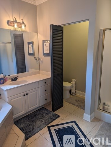 A bathroom with a white sink and a black door.