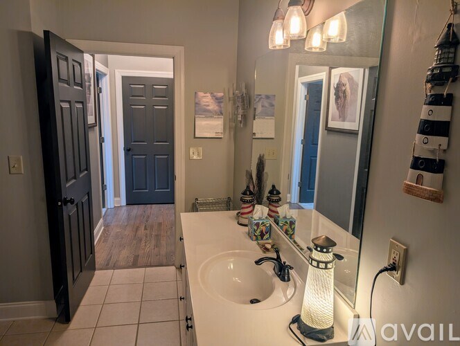 A bathroom with a white sink and a mirror.