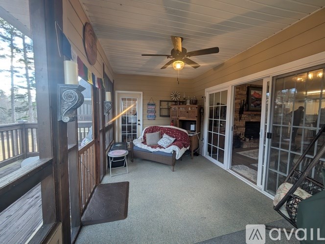 A balcony with a couch and a table is visible.