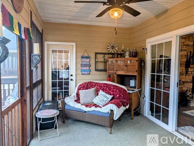 A cozy bedroom with a bed, a chair, and a table.