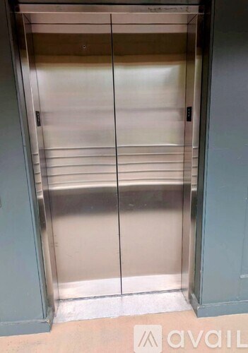 A stainless steel elevator with a closed door.