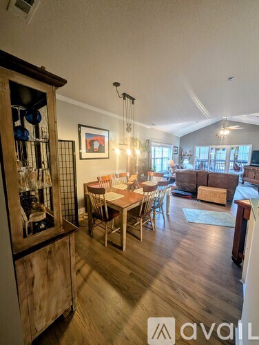 A kitchen with a wooden table and chairs is shown in the image.