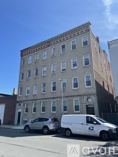 A white van with a USPS logo is parked in front of a building.