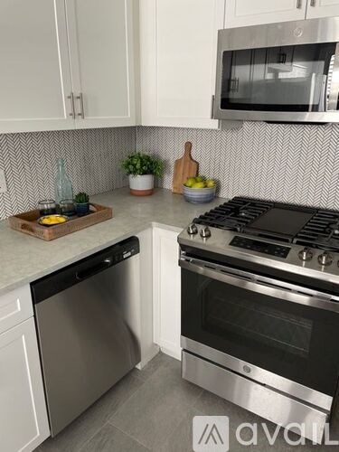 A kitchen with a stove top oven and a microwave above it.