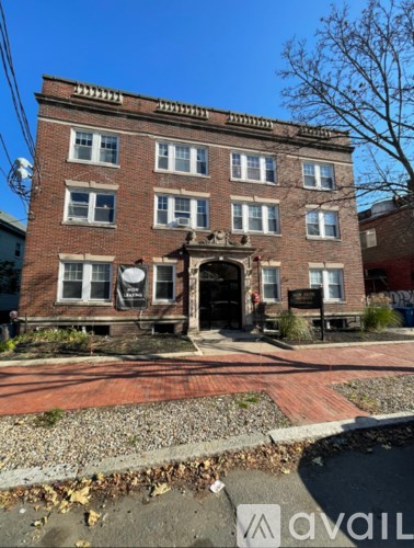 A brick building with a black door and windows.