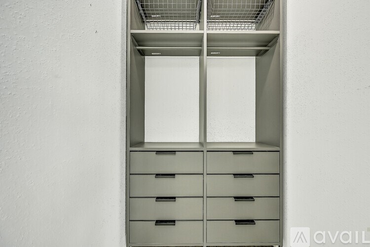 A metal cabinet with drawers and a vented top.