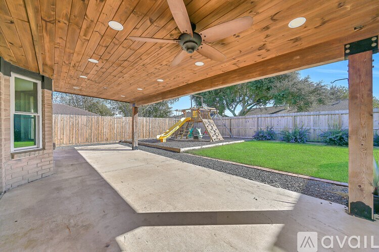 A room with a fireplace and a ceiling fan.