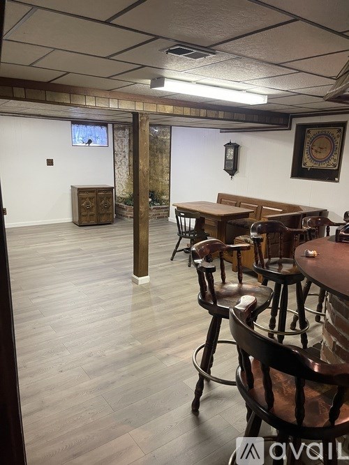 A room with wooden floors and furniture.