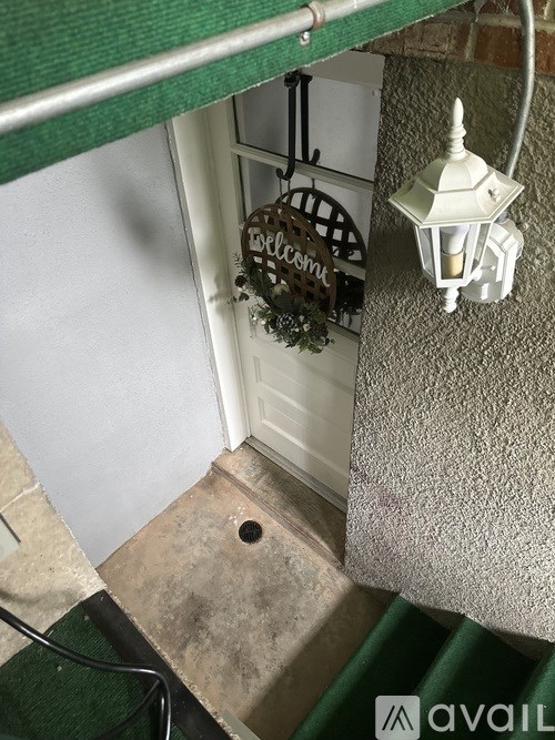 A white door with a wreath on it.