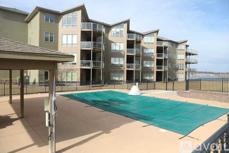 Apartment complex with a pool and covered patio.