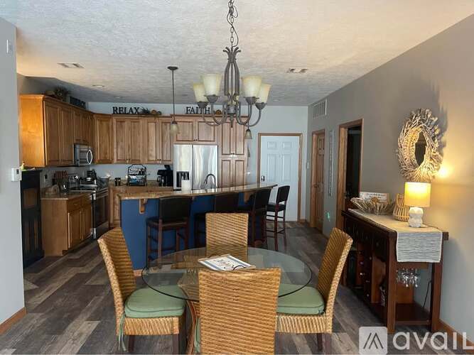 A dining room with a table set for four.
