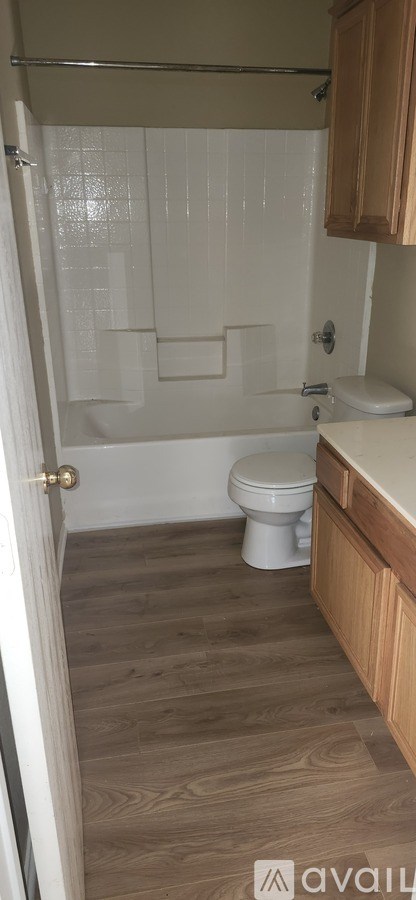 A bathroom with a toilet, sink, and shower.