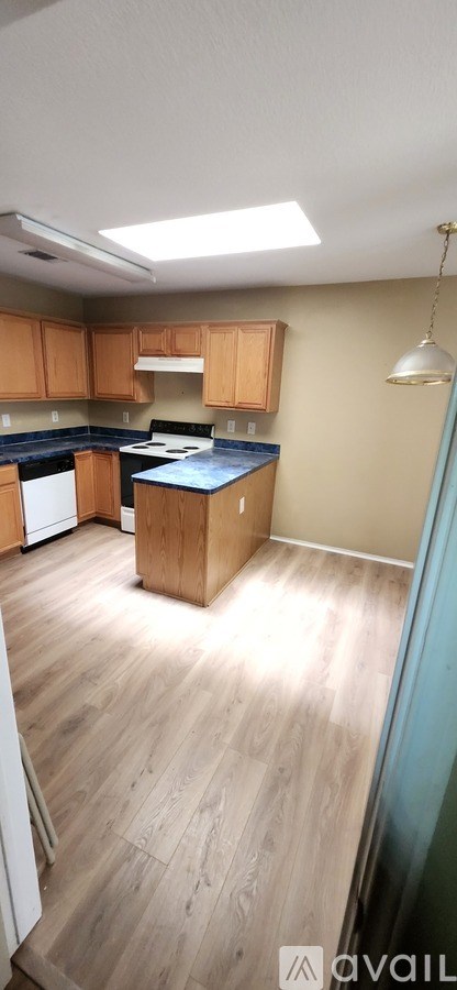 A kitchen with wooden cabinets and a blue countertop.