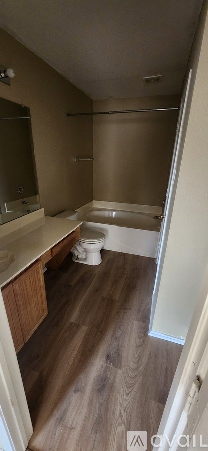 A bathroom with a toilet, sink, and bathtub.