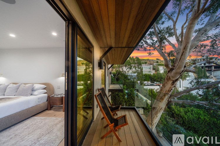 A bedroom with a large bed and a view of the city.