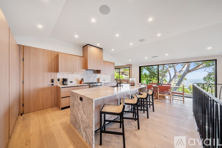 A modern kitchen with wooden cabinets and a large island.