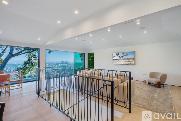 A modern living room with a large window overlooking a cityscape.