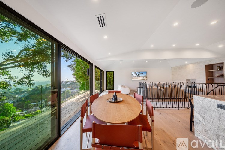 A modern dining room with a large table and chairs.