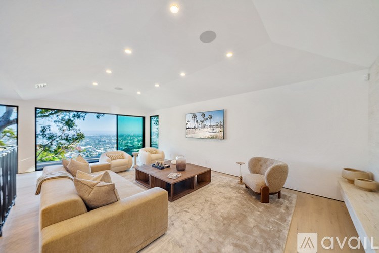 A living room with a couch, chairs, and a coffee table.