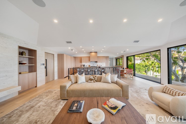 A modern living room with a wooden floor and a large window.