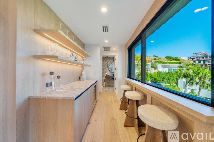 A kitchen with wooden cabinets and a marble countertop.