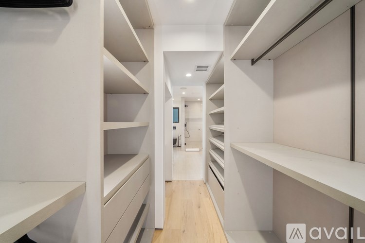 A long hallway with shelves on both sides.