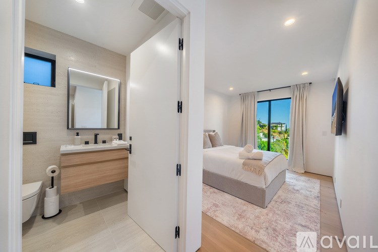 A bedroom with a bed, a dresser, and a mirror.