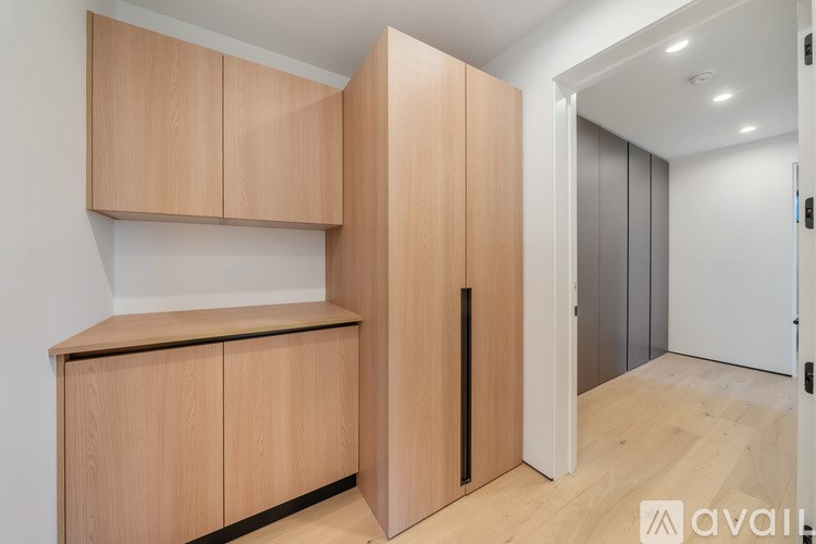 A wooden cabinet with a black handle is in the foreground.