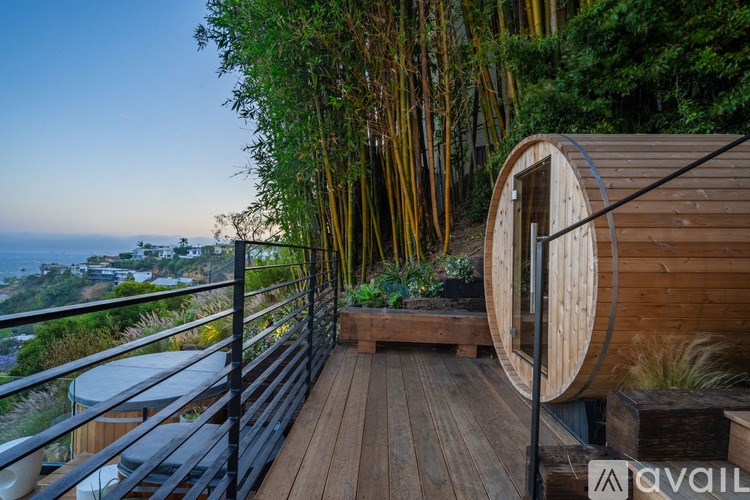 A wooden deck with a railing and a view of the ocean.