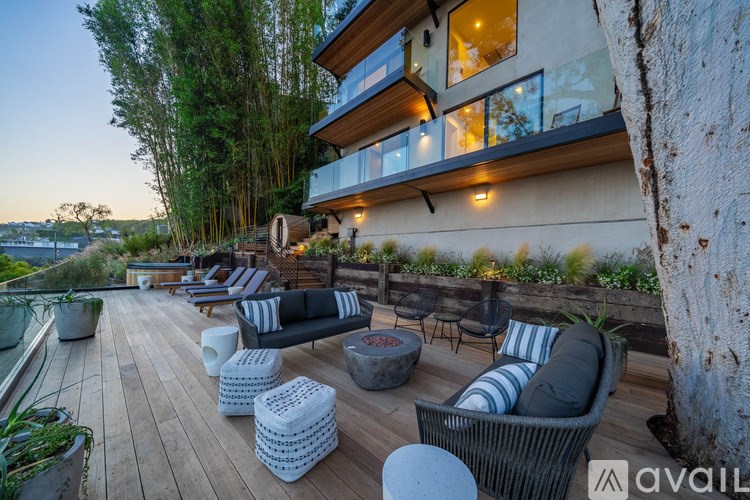 A modern outdoor seating area with a view of the water.