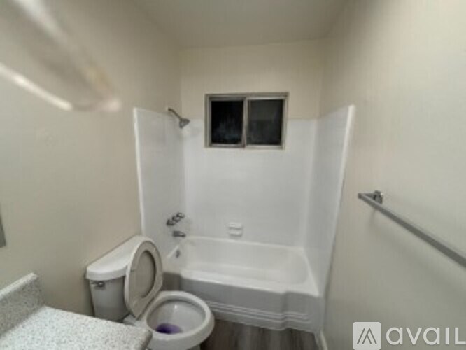 A small bathroom with a toilet, sink, and bathtub.