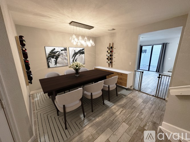 A dining room with a wooden table and chairs.